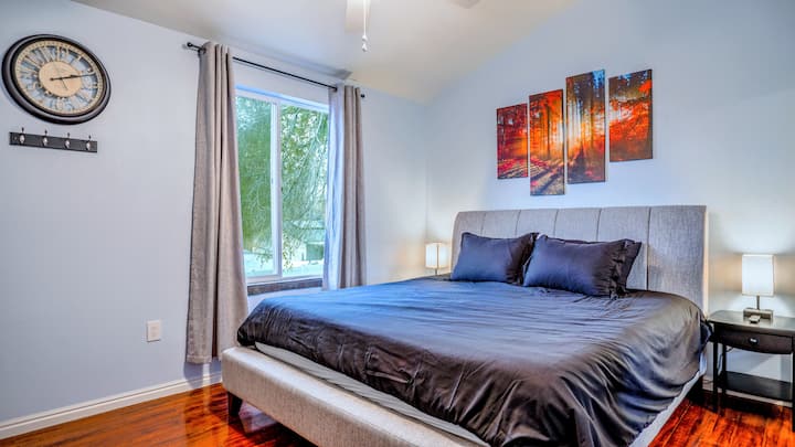 Master bedroom with large comfy king mattress and sliding window