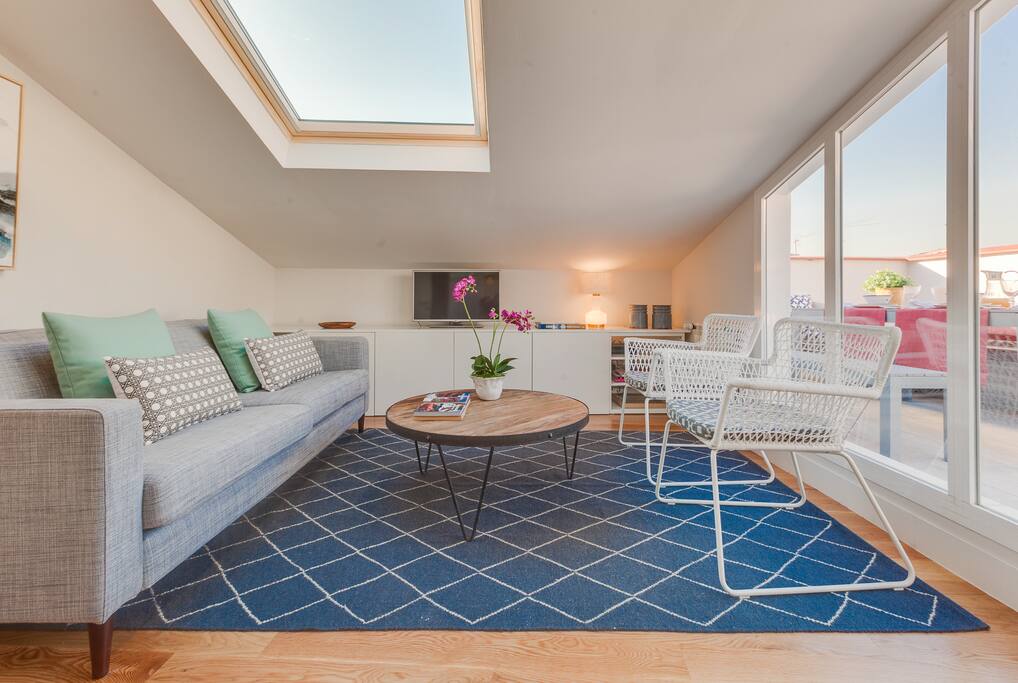 Main Floor: Entrance opens to living room area, consisting of a 3 seater sofa, a wooden round coffee table, two chairs, a floor lamp, a long cabinet, and flat screen TV and DVD player.