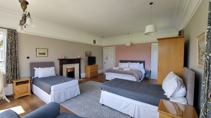 Room 1, a large family room with a super-king and two singles. This room can also be a quad room, with four singles. It's the largest room, and the ensuite bathroom has been recently updated. 
