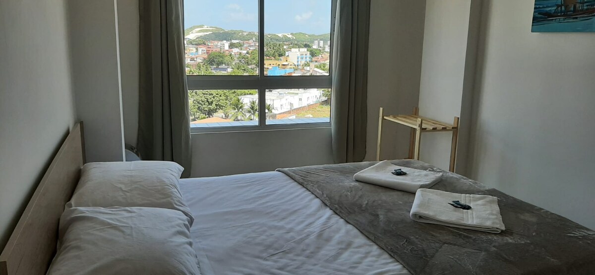Double bed overlooking Morro do balca and air circulator.
