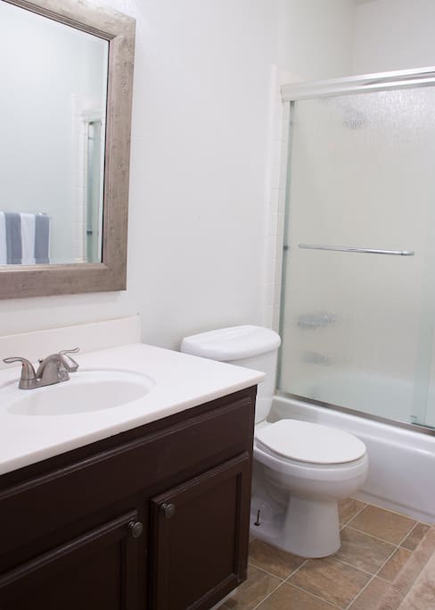 Shared upstairs bathroom with tub and shower