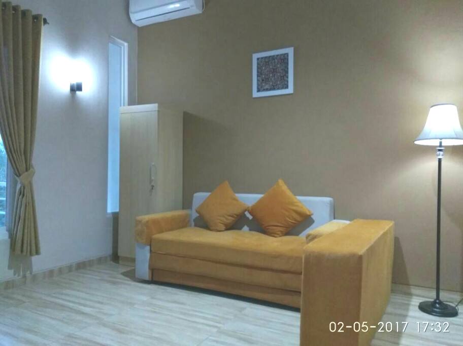 Sofa Bed in room equipped with AC and TV local channel.May be used as 2nd living room on 2nd floor
