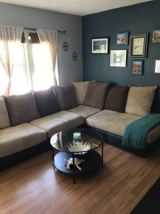Open living room with a comfy couch perfect for an extra guest or use the open space for the air mattress - either way it's a perfect fit.