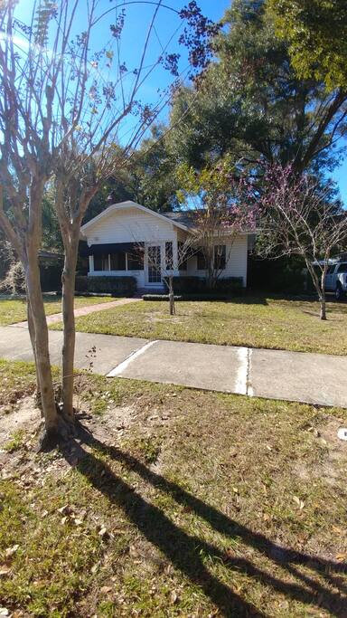 Front of home. House is shaded by mature oaks.