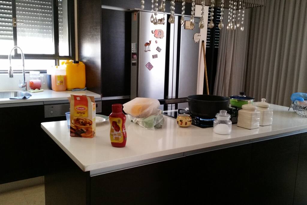 Big kitchen with cooking isle in the middle.