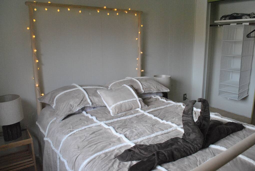Comfortable bed w/ clean bed sheets, blanket, pillow cases, pillows, and towels