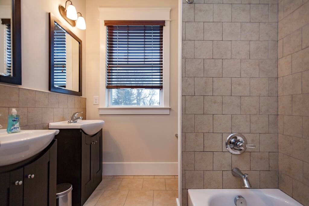 Private bath with his and her vanity sinks! Note: there is a shower nozzle - it's cut off in the photo!