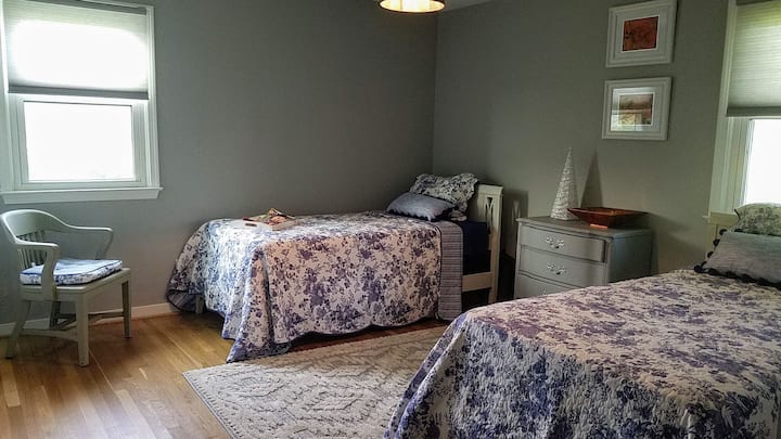Bedroom #2 -Autumn Harvest features a twin bed, full bed, a closet, and drawers.