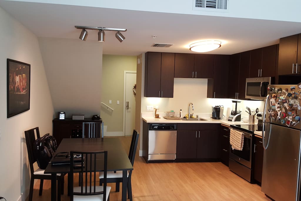 Kitchen with pans, pots, mixer, ice maker, coffee machine, glasses, utensil, plates, etc.