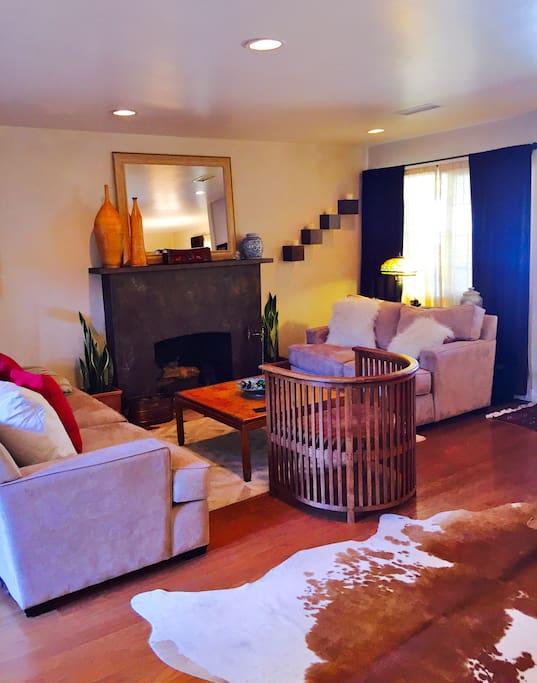 Living room with fireplace open to kitchen with island bar