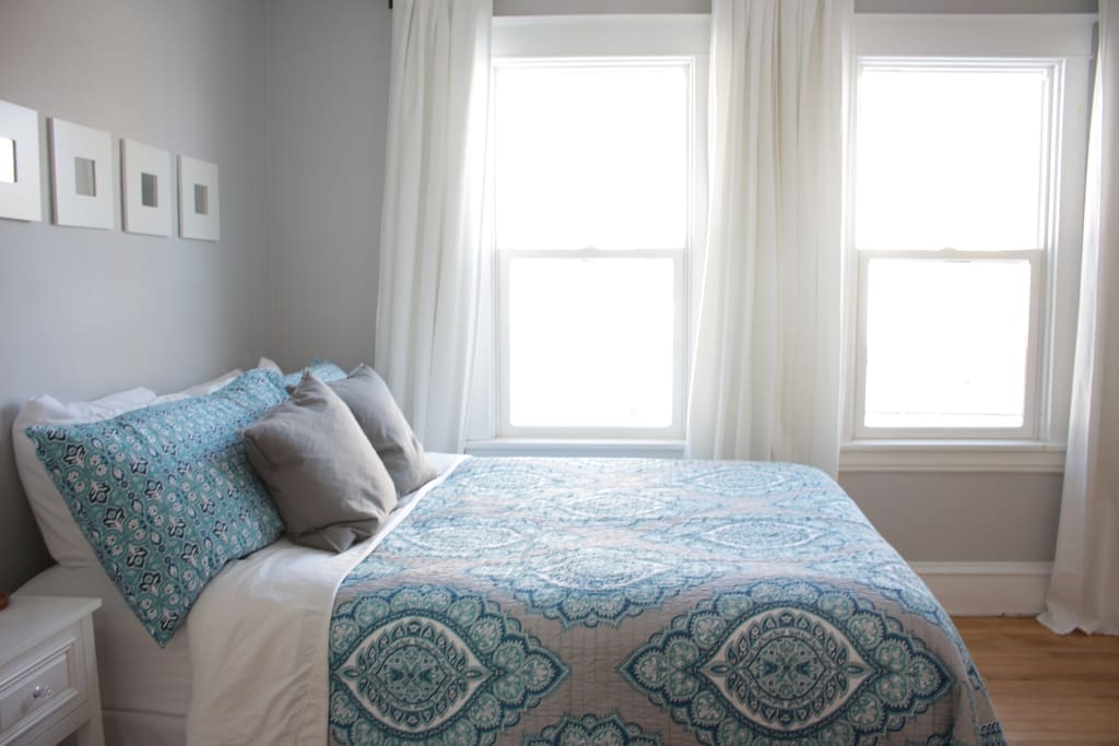 Queen bed with cozy duvet and extra blankets for colder nights.