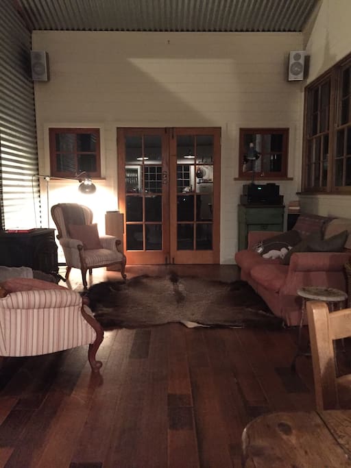 Nighttime in the main living area fire side, music on, piano available to use!