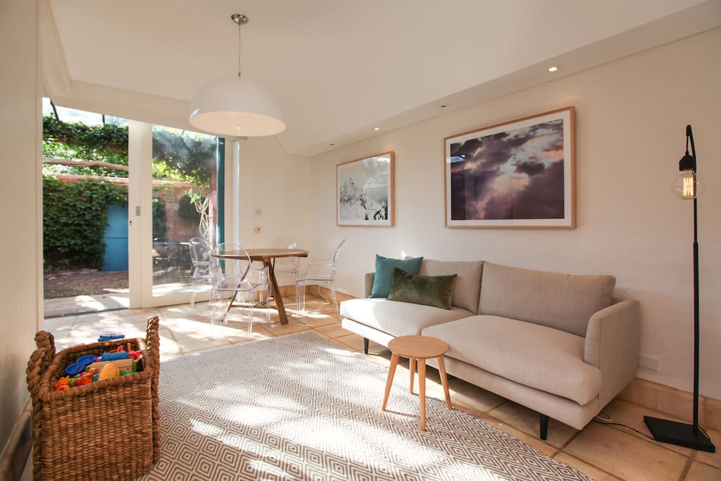 Casual living area opens onto sundrenched courtyard with rear lane access