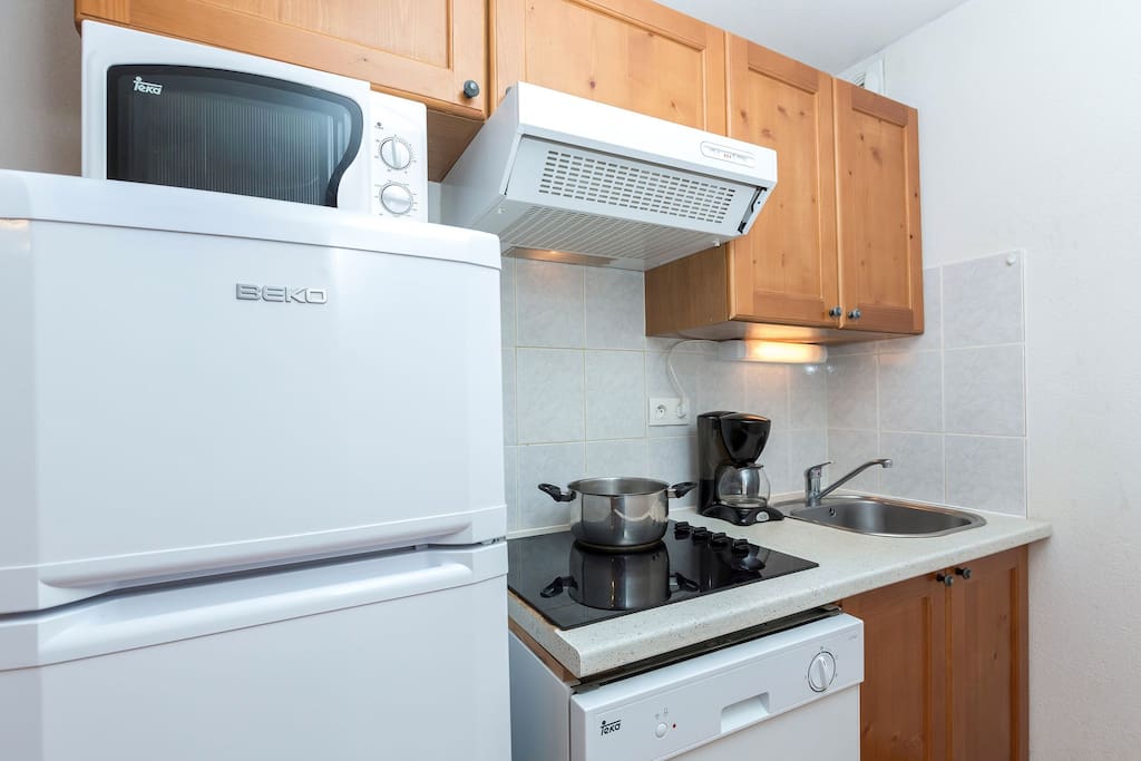 This unit features a fitted and well-equipped kitchenette with electric hotplates, fridge, microwave/grill, dishwasher, coffee machine, and kettle to prepare delicious meals in your apartment.