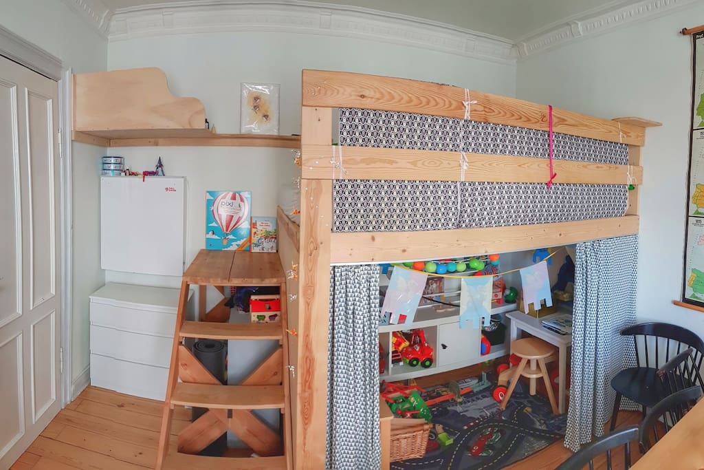 Elevated double bed + baby changing area to the left (folds out) + playing area under the bed