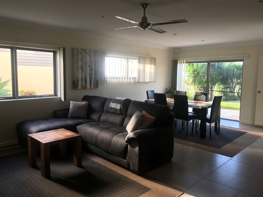 Spacious lounge and dining area. Tiled floors with floor rugs. Gas heating and ceiling fans