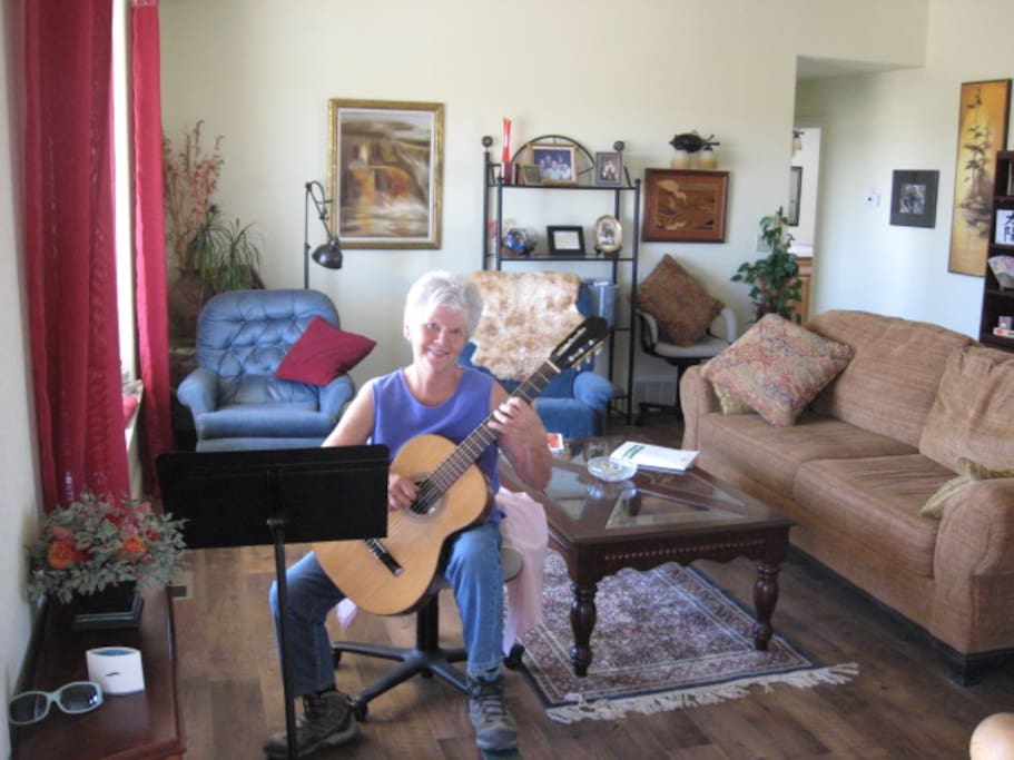 In my living room, playing guitar