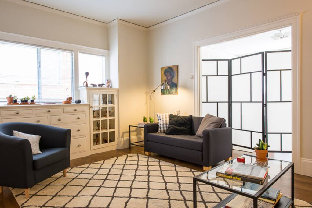 Living room, looking towards the bedroom, past the screen. Bright and comfortable.