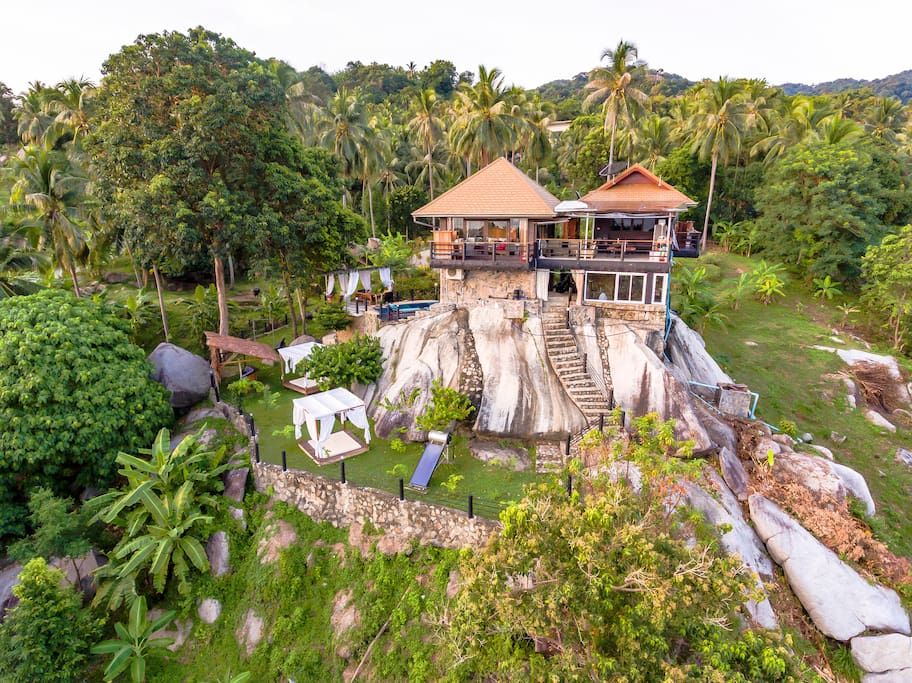 Front of the villa standing on a rock with garden and pool area