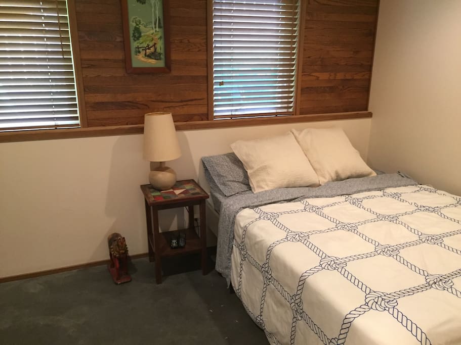 Cozy Queen size bed with pillow-top mattress pad.