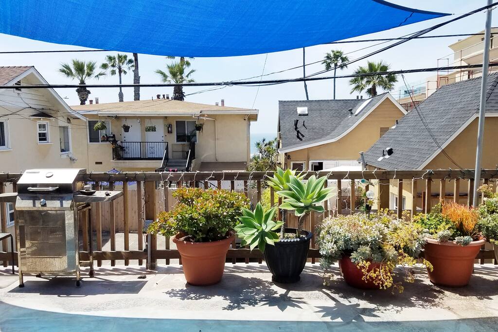 We have a nice shared deck with a grill for your outdoor cooking enjoyment with overhead shade sails for your comfort