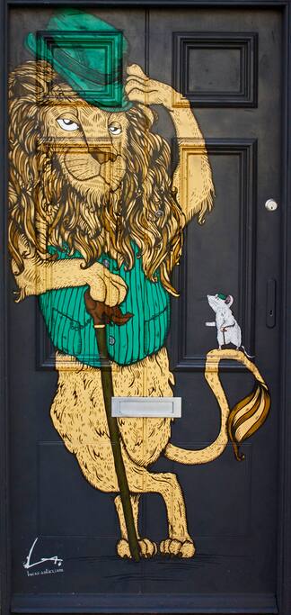 The front door to this apartment features a piece of art by renowned local artist Alex Lucas
