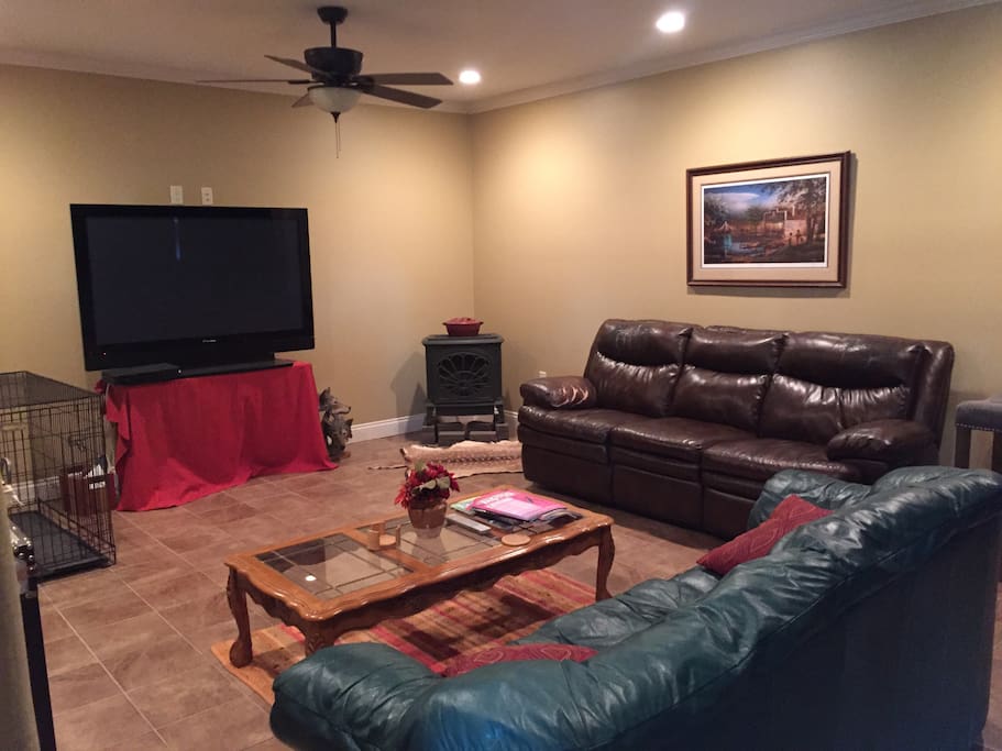 Interior living room with large screen plasma tv and gas fireplace.