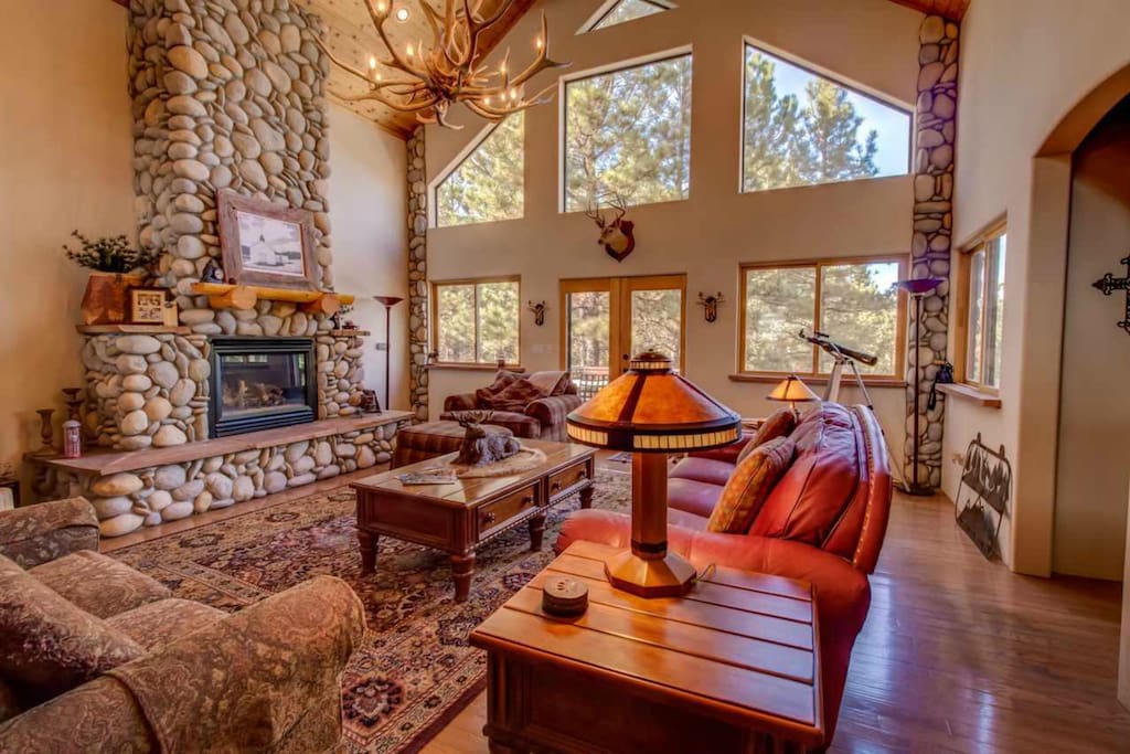 The great room welcomes you with river stone accents, wood beams and more.