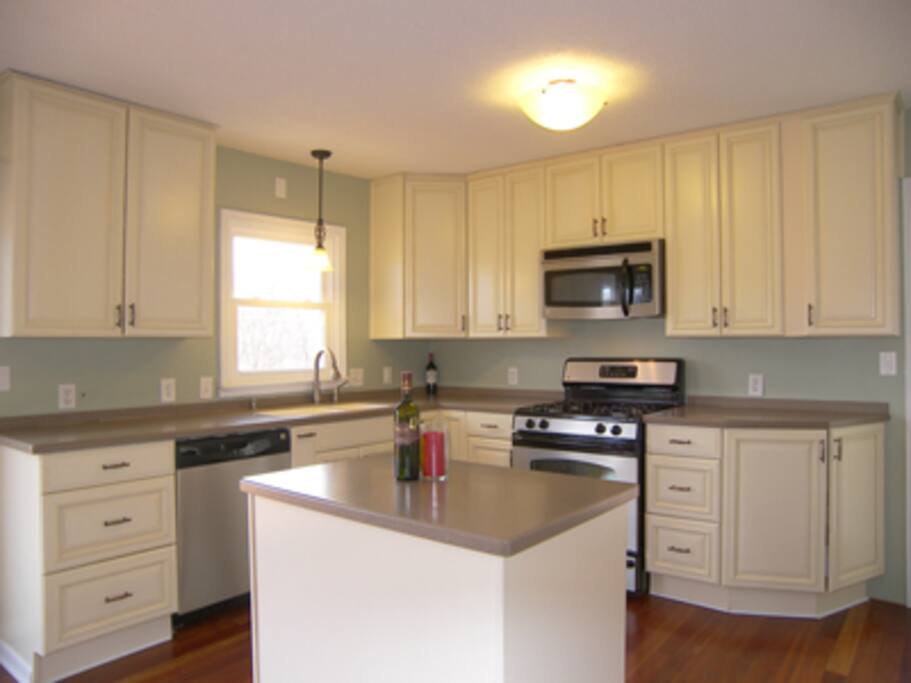 Kitchen includes toaster, microwave, various pots and pans.