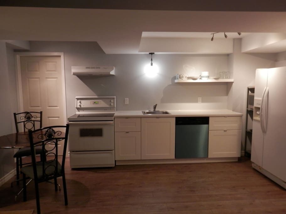 Kitchen with dishwasher, stove, microwave & side by side fridge/freezer