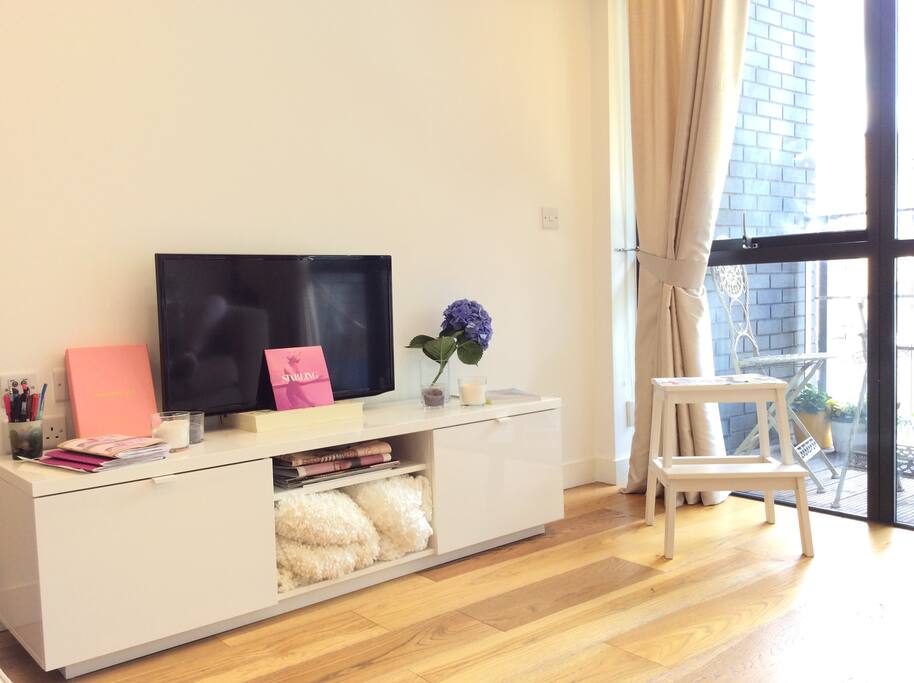 TV and books inc quilts for resting on the sofa