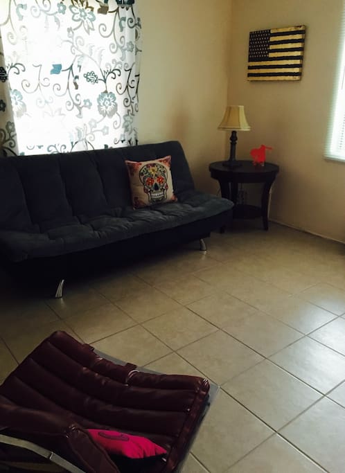 Clean, spacious guest bedroom, furniture moves from a couch to a bed, two windows, airy, bright. Private room at end of hall, bathroom in hall between charming closets & bedroom
