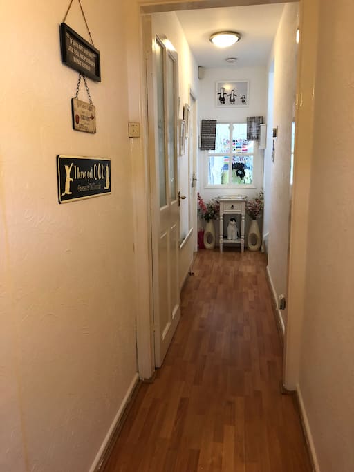 Welcome to our home through our long and bright hallway.