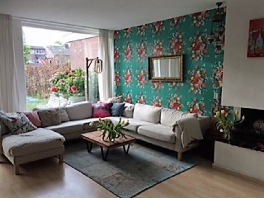 cosy and colorful living with a fireplace and piano