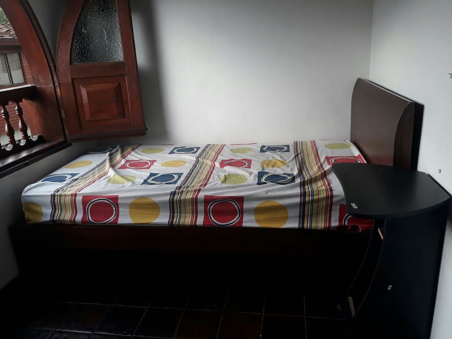 Simple bed and night table with wheels.