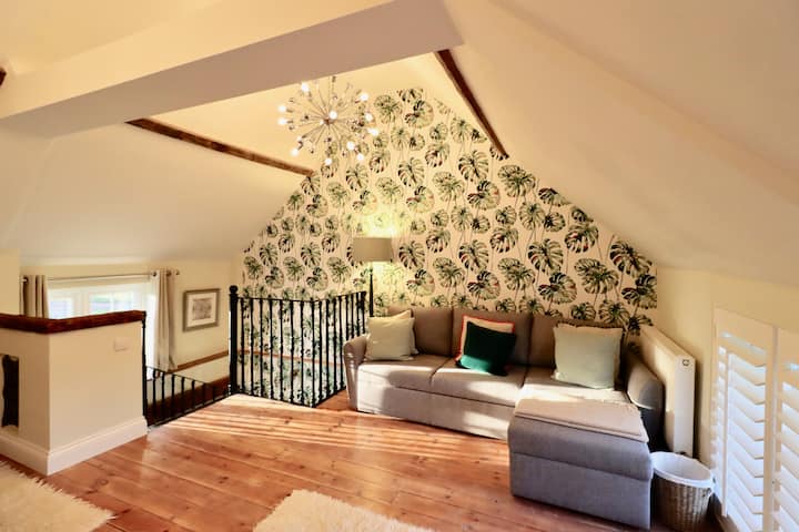 The double height ceiling upstairs gives a fabulous spacious feel. An L-shaped sofa and lots of cushions makes this a perfect place to relax after a day exploring. Enjoys both east & west facing windows so you are bathed in light. 