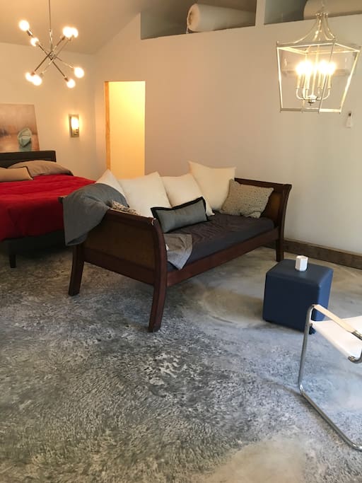 View towards closet from open space overlooking living area with twin sleeper and king bed. Above, you’ll see two cubbies each with a twin mattress.