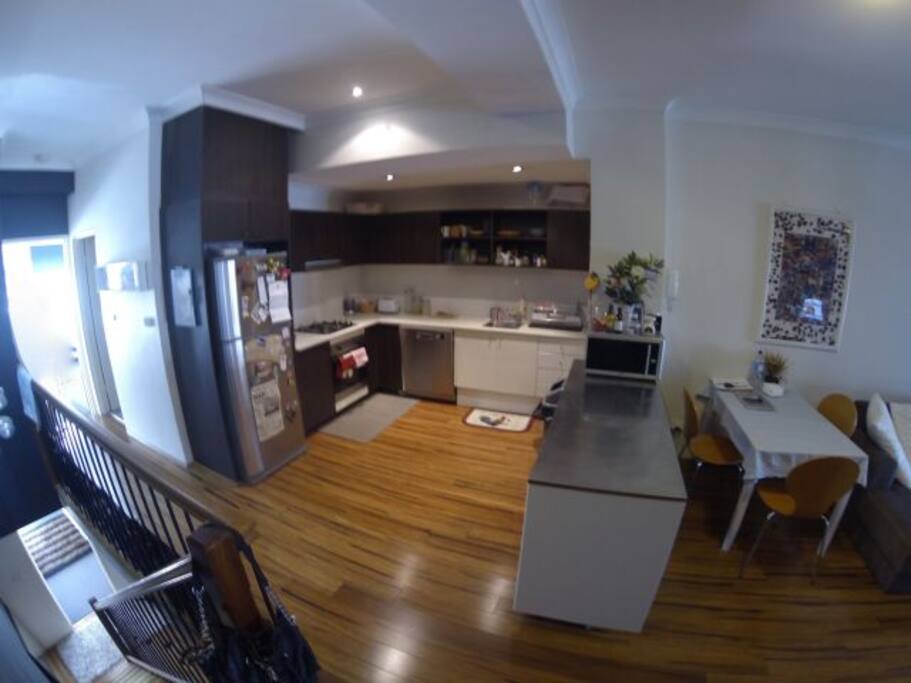 Large kitchen with dishwasher, oven, stove and large fridge