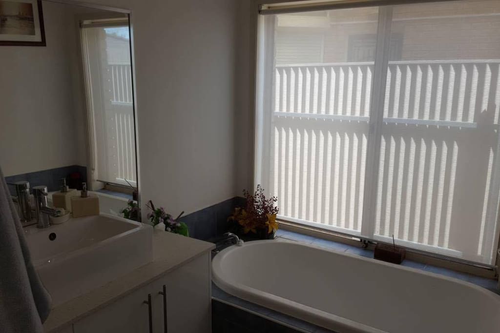 Bathroom with glass-door shower, bath and basin