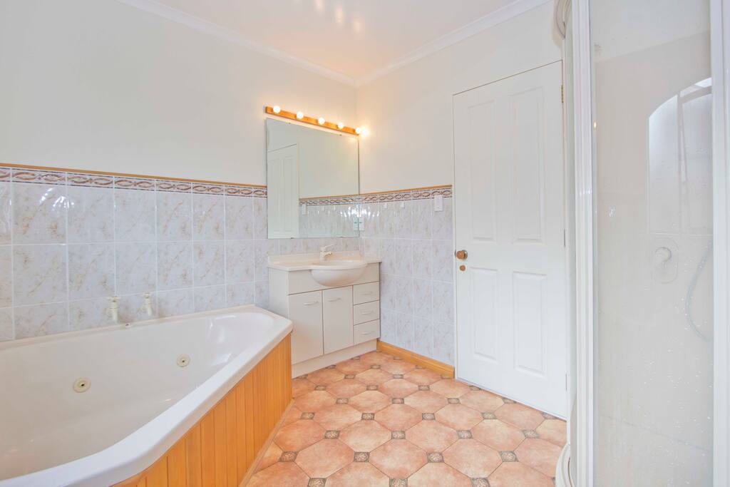 Upstairs bathroom complete with Spa bath, shower and toilet