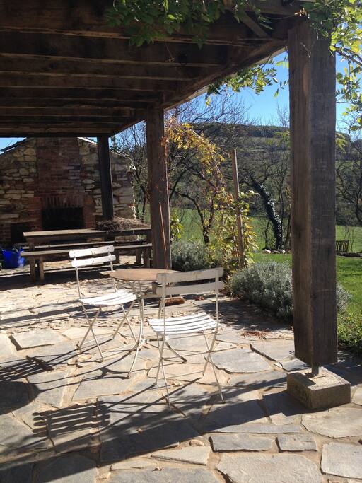 Sheltered outside area: table, chairs, hanging seat, and hammock