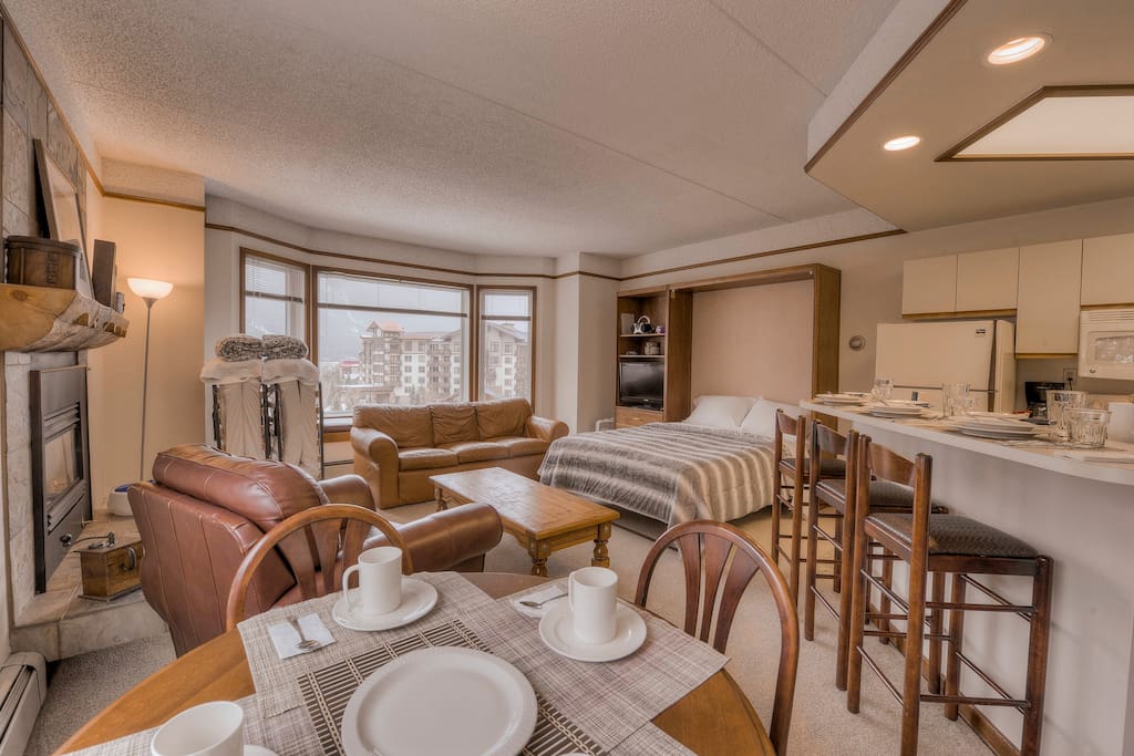 View from dining table with the open Queen Murphy Bed & the closed Roll-Away Beds.
