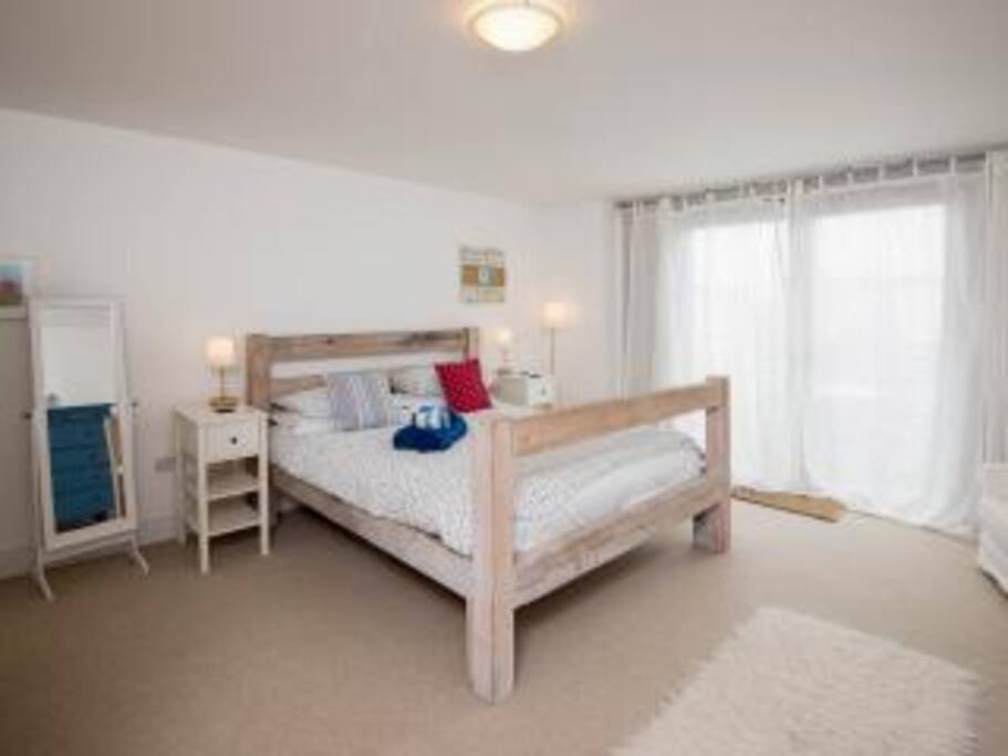 Top floor master bedroom with ensuite shower room and deck with table and chairs