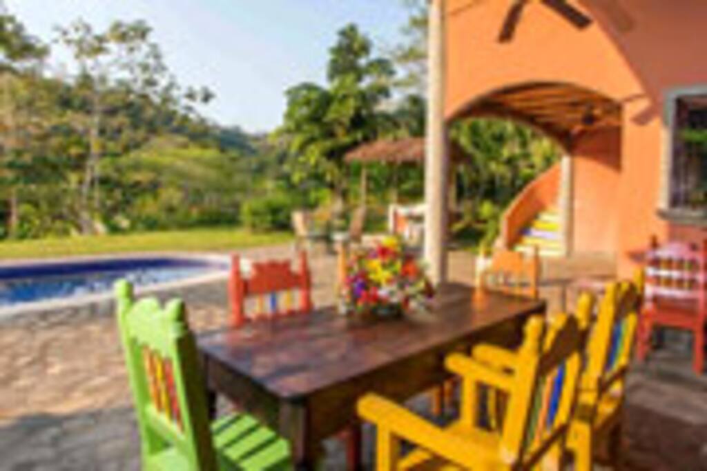 Dining Patio, seats 8, with view of the rain forest. Bar-b-que hut to the right