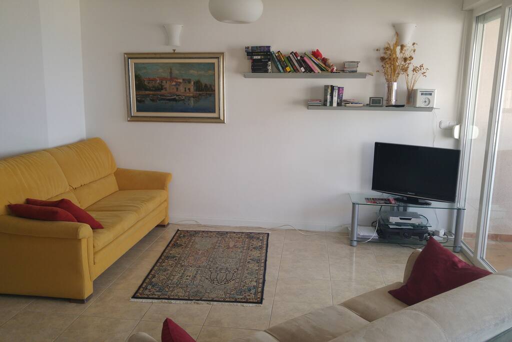 Spacious and bright living room with sea view and plenty of seating.