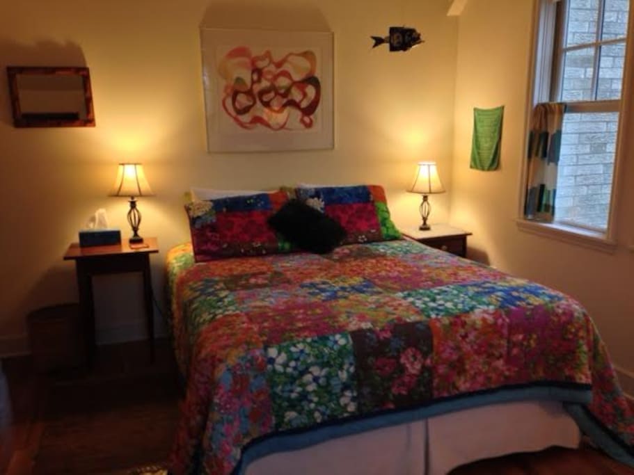 Super comfortable Queen bed with ceiling fan, windows, and light