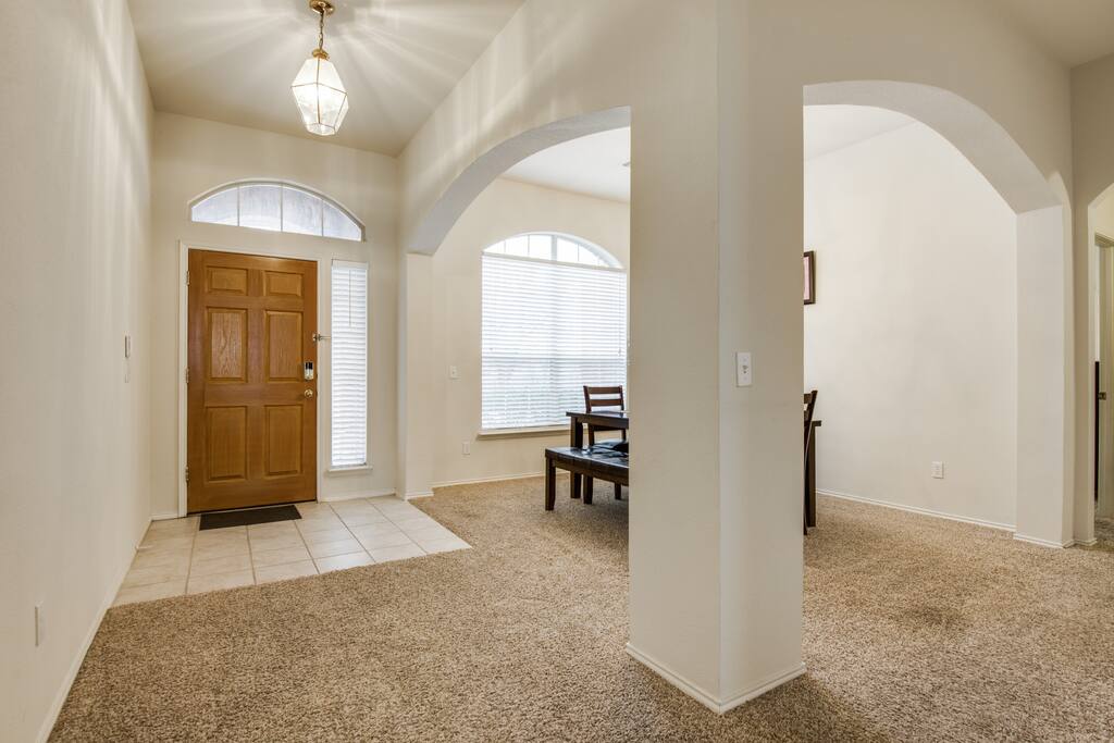 View of the front door and dining room to the side