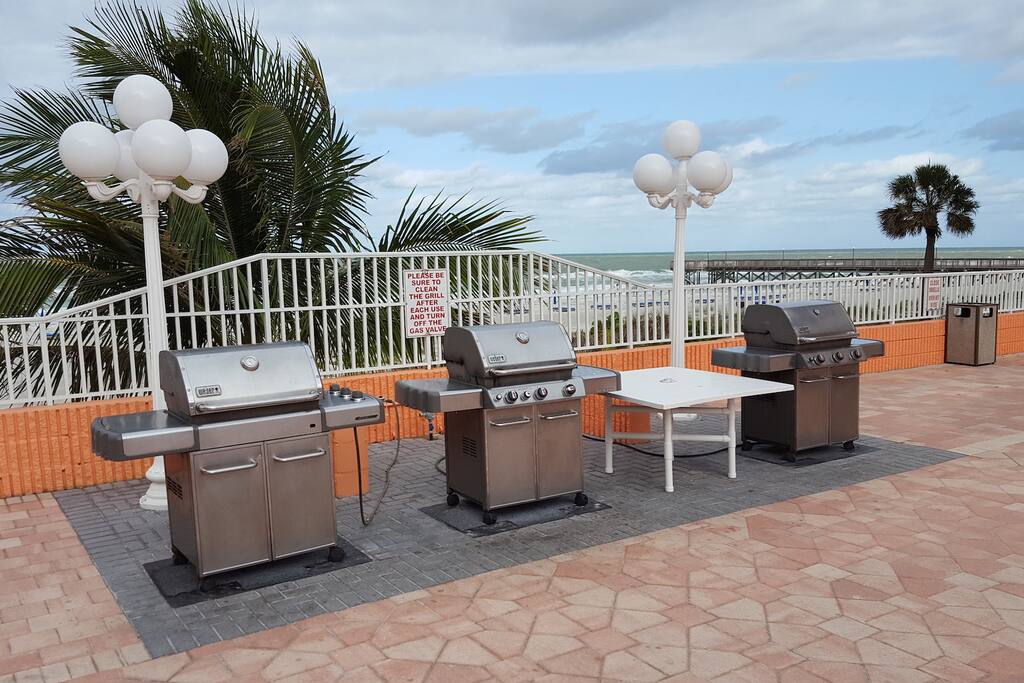 Three gas grills at the poolside
