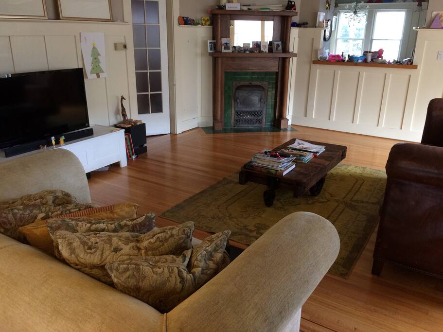Living room with x2 large sofas (gold sofa converts to sofa bed) and X1 armchair. Large screen TV with DVD/PS3 player. Note: child clutter will be removed for guests