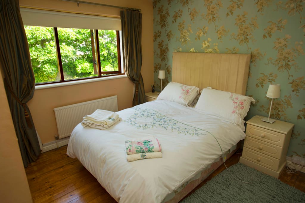 Spacious bedroom surrounded by nature.